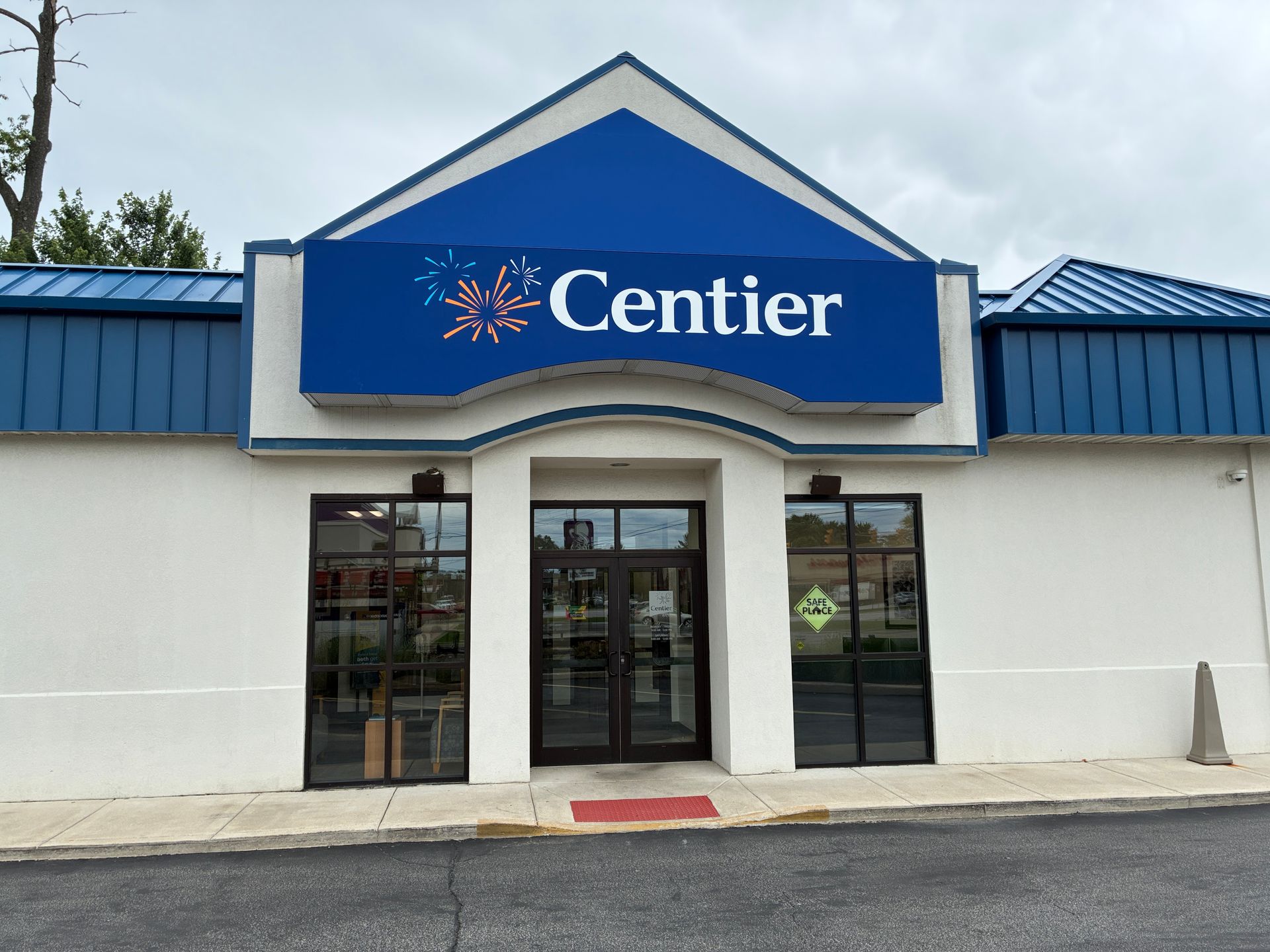Centier bank storefront with blue sign and glass entrance under a white and blue facade