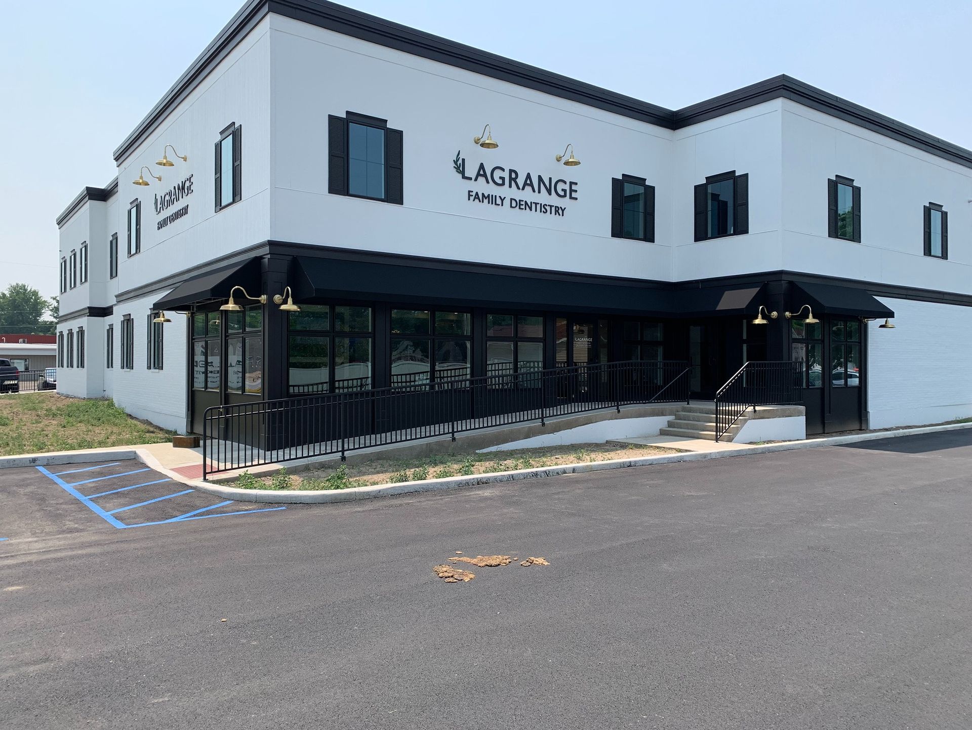 Exterior of LaGrange Pediatrics, a white two-story building with black trim and a glass storefront.