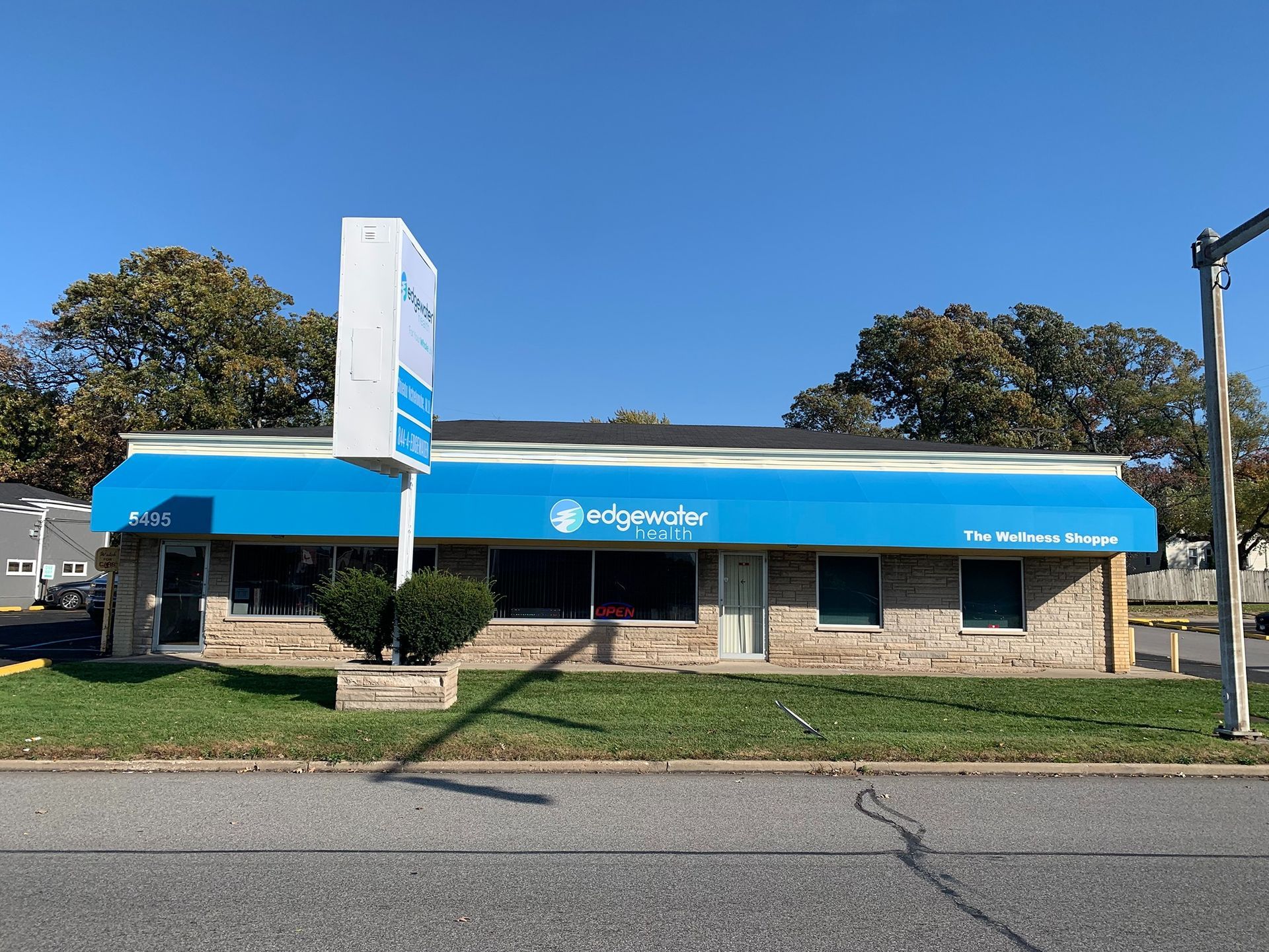 OneMain Financial office with blue awning and sign on a street corner