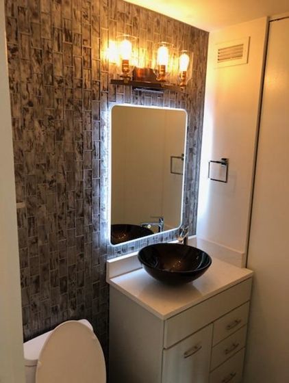 A bathroom with a sink and mirror