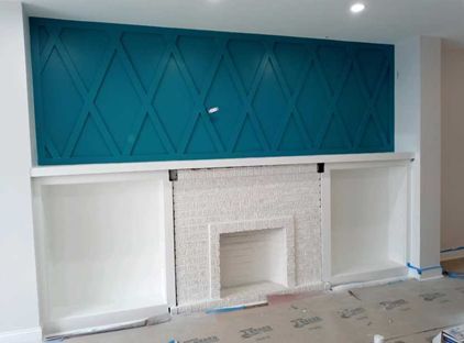 A living room with a fireplace and  blue wall