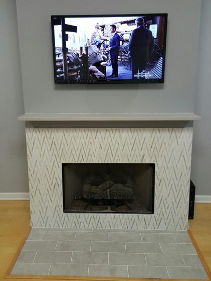 A fireplace with a flat-screen TV above it