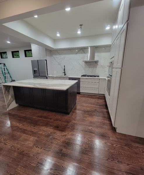 A kitchen with a large island in the middle of the room