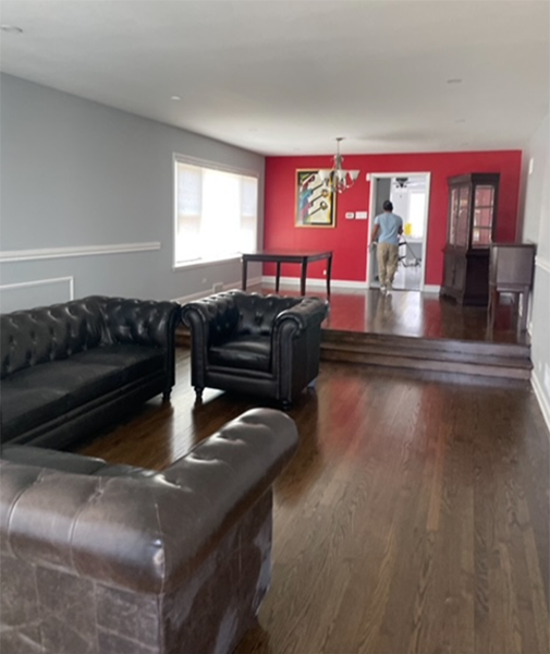 A living room with a couch and two chairs