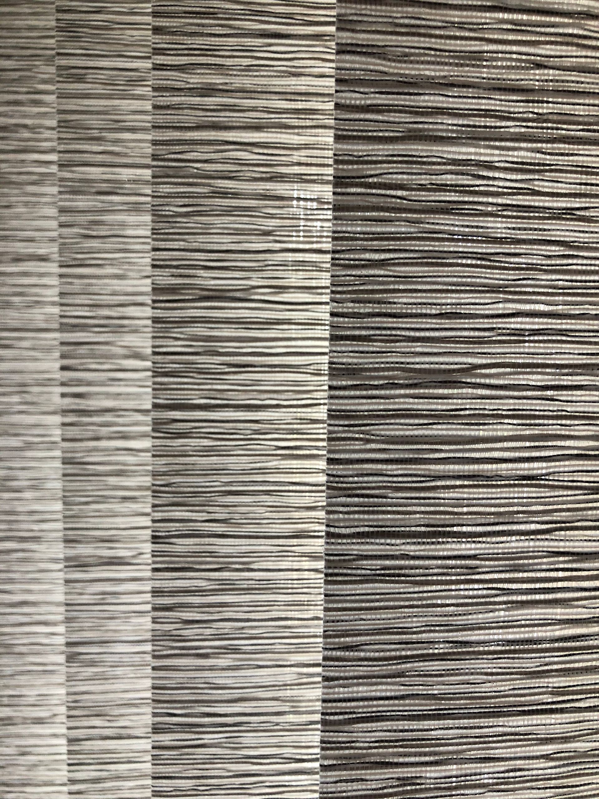 Horizontal striped window blind, varying shades of gray and white.