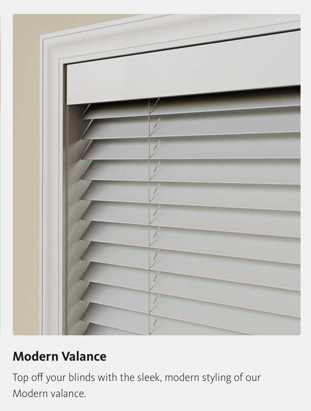 White venetian blinds with a modern valance, close-up shot.