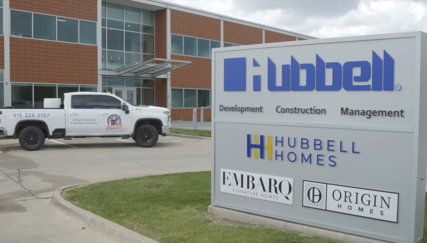 Office building with Hubbell signs and a white pickup truck parked outside.