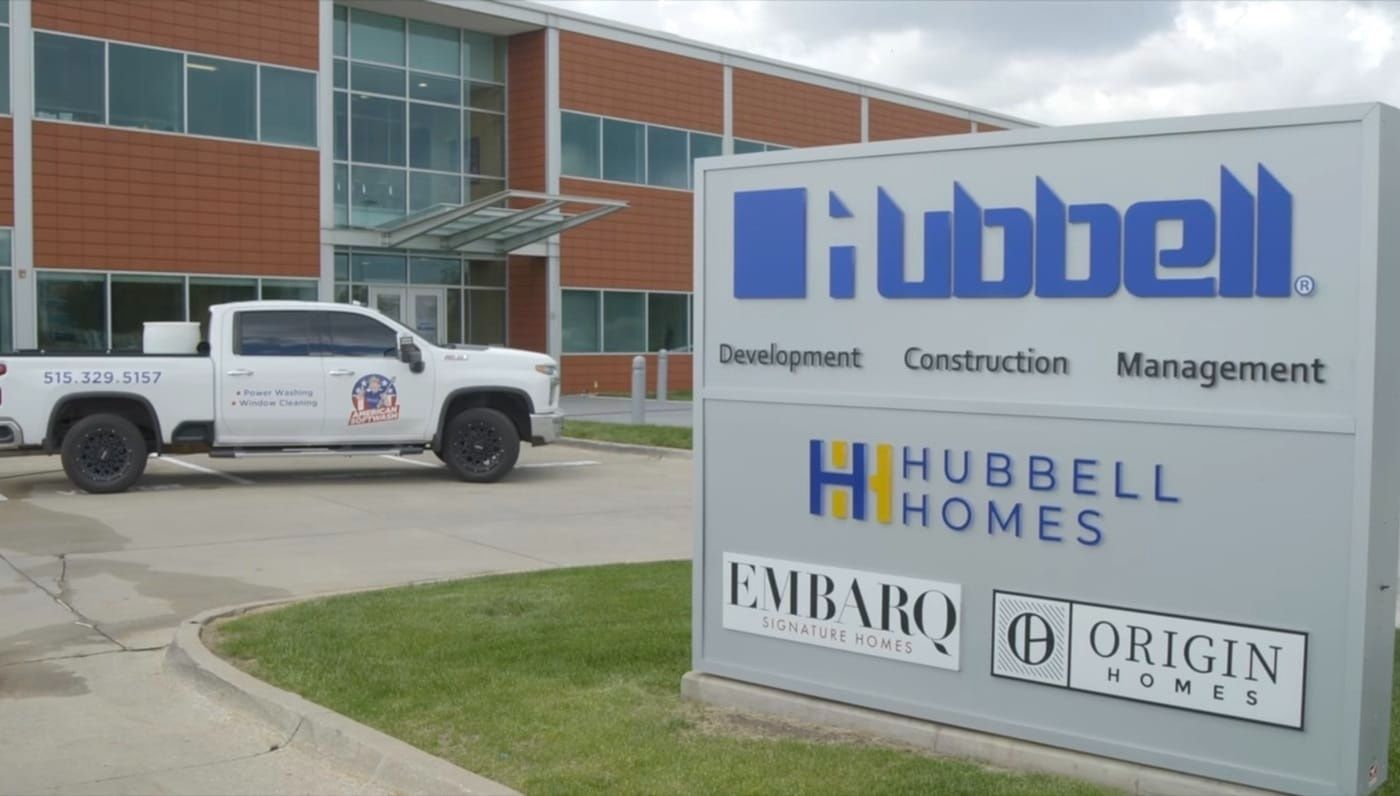 Hubbell sign outside an office building with a white pickup truck parked nearby