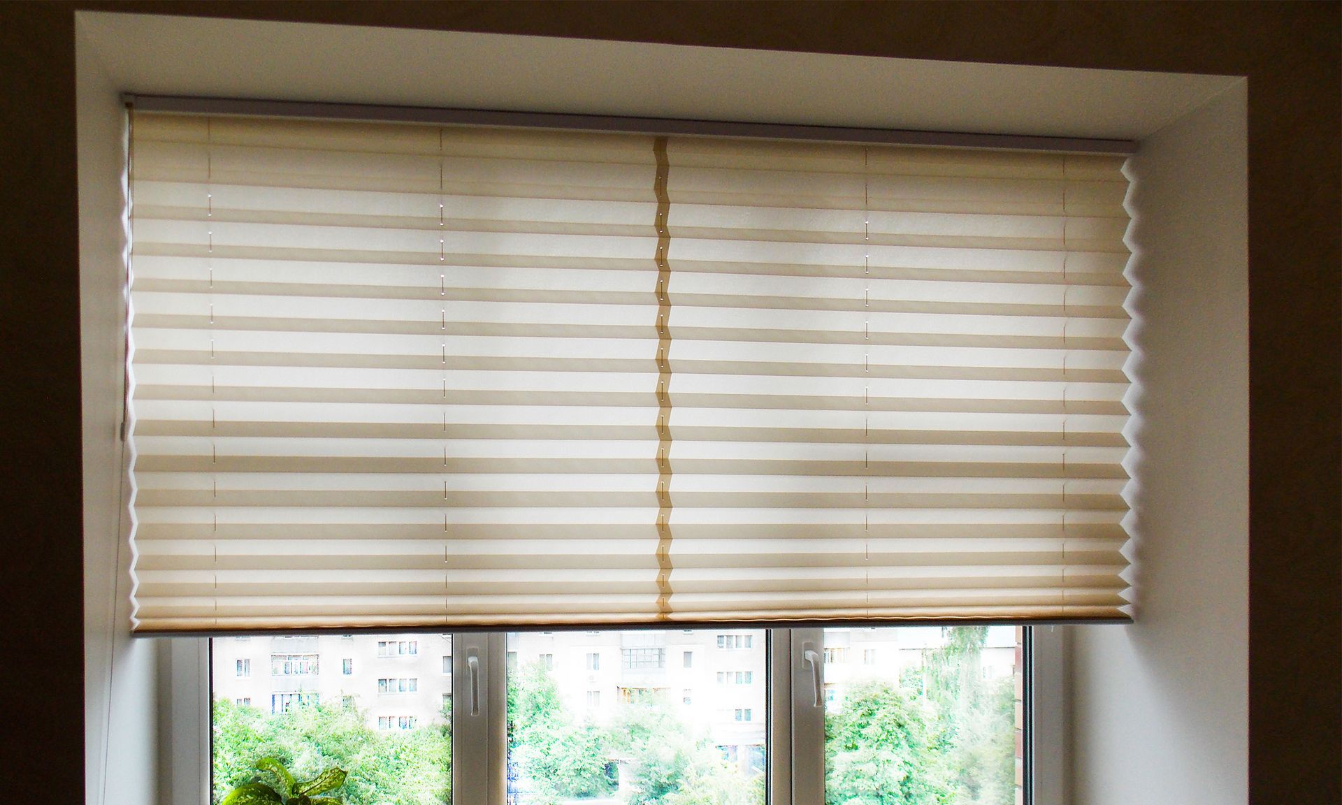 A window with a pleated blind on it