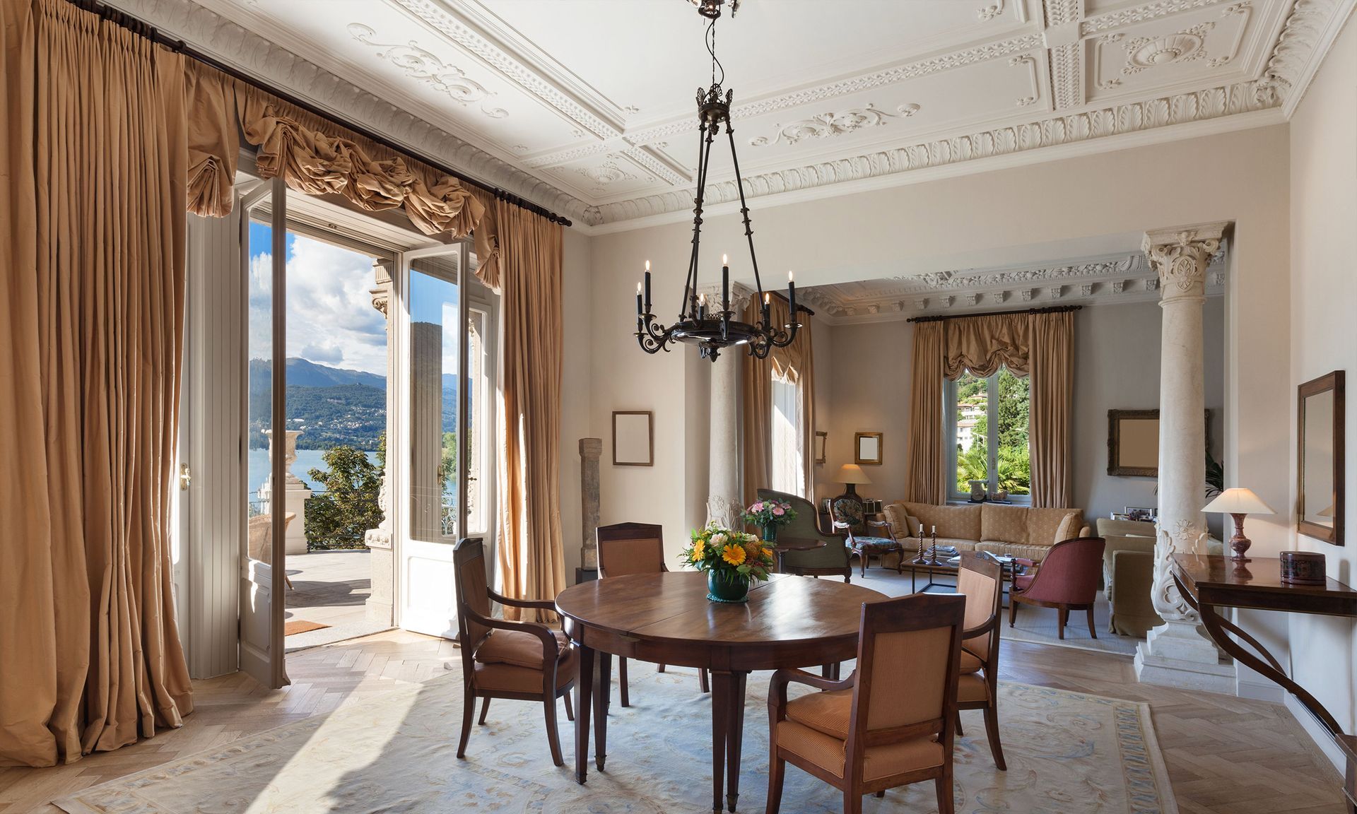 A large dining room with a table and chairs and a chandelier.