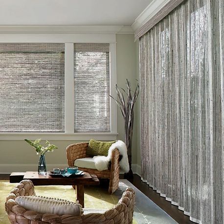 A living room with a chair , table , and curtains.