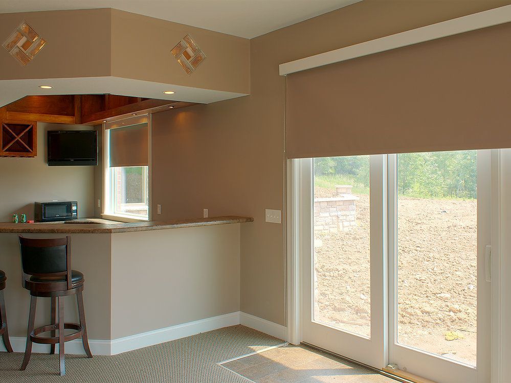 A living room with a bar and sliding glass doors
