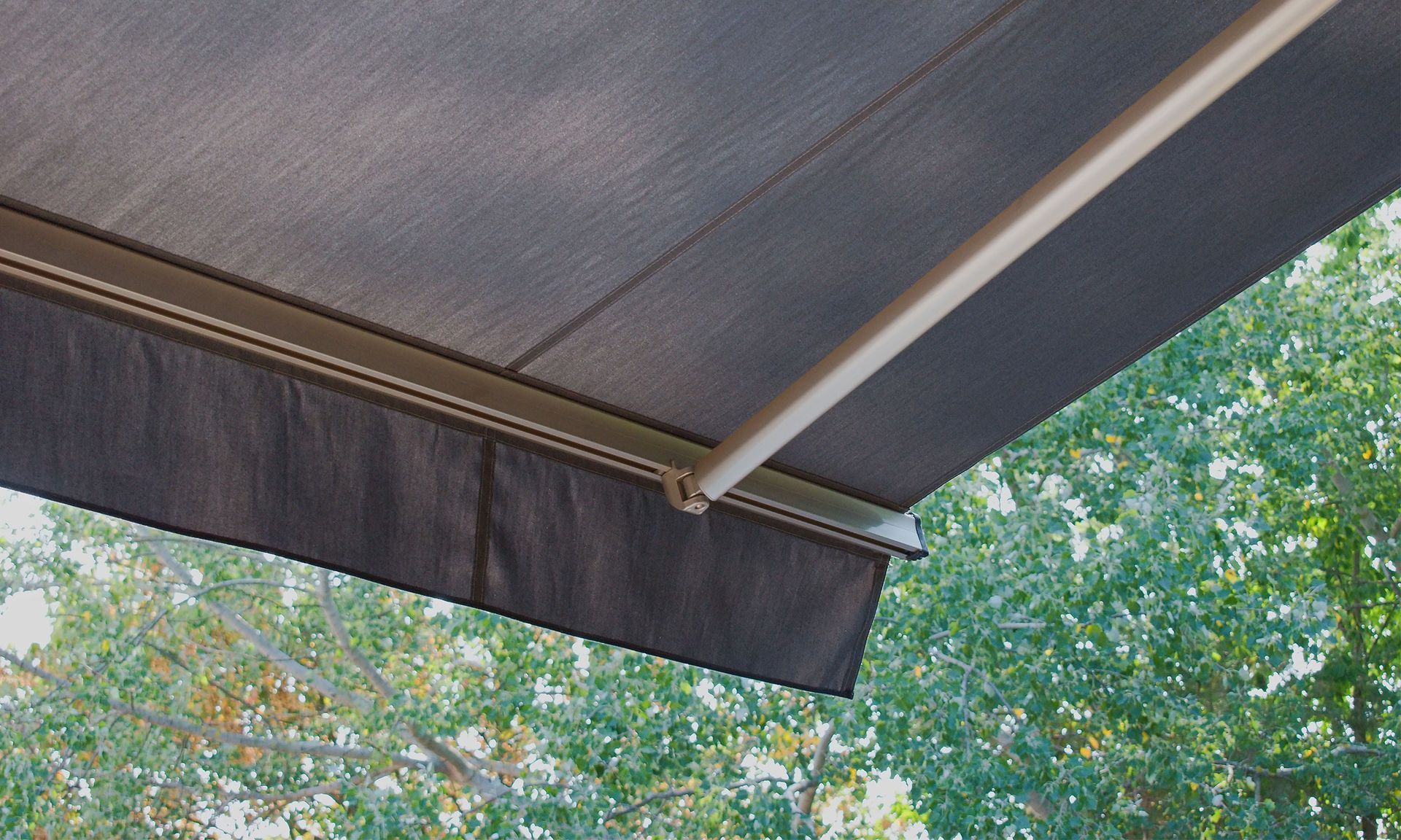 A close up of an awning with trees in the background