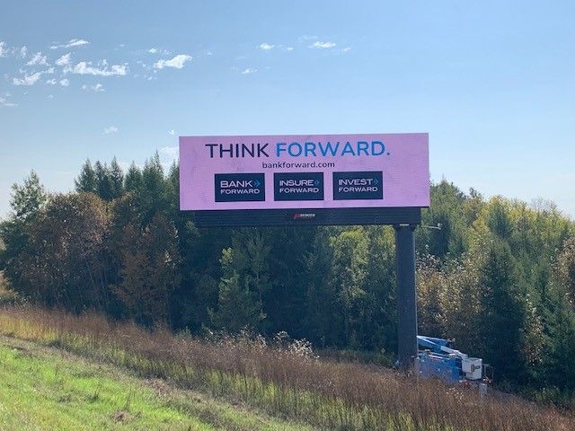A billboard on the side of a highway