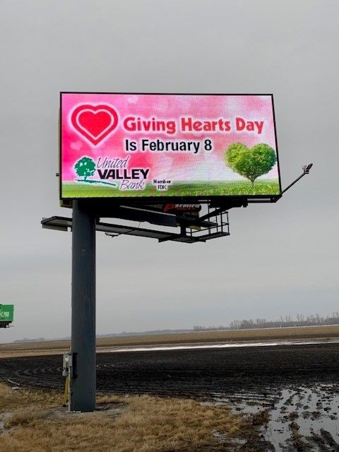 A billboard that says giving hearts day