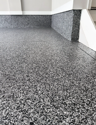 Gray speckled epoxy garage floor and wall.