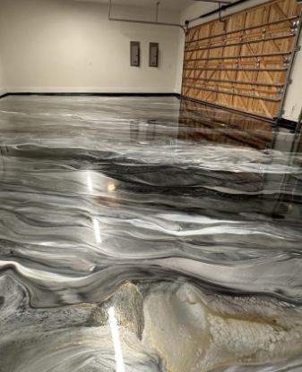 Metallic epoxy garage floor with swirling gray, black, and gold patterns.