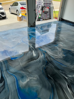 Metallic epoxy garage floor with blue, silver, and black swirls.