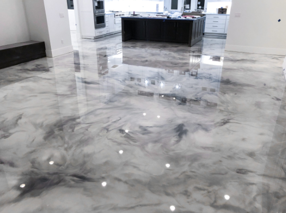 Shiny epoxy floor with gray and white marbled effect in a modern kitchen.