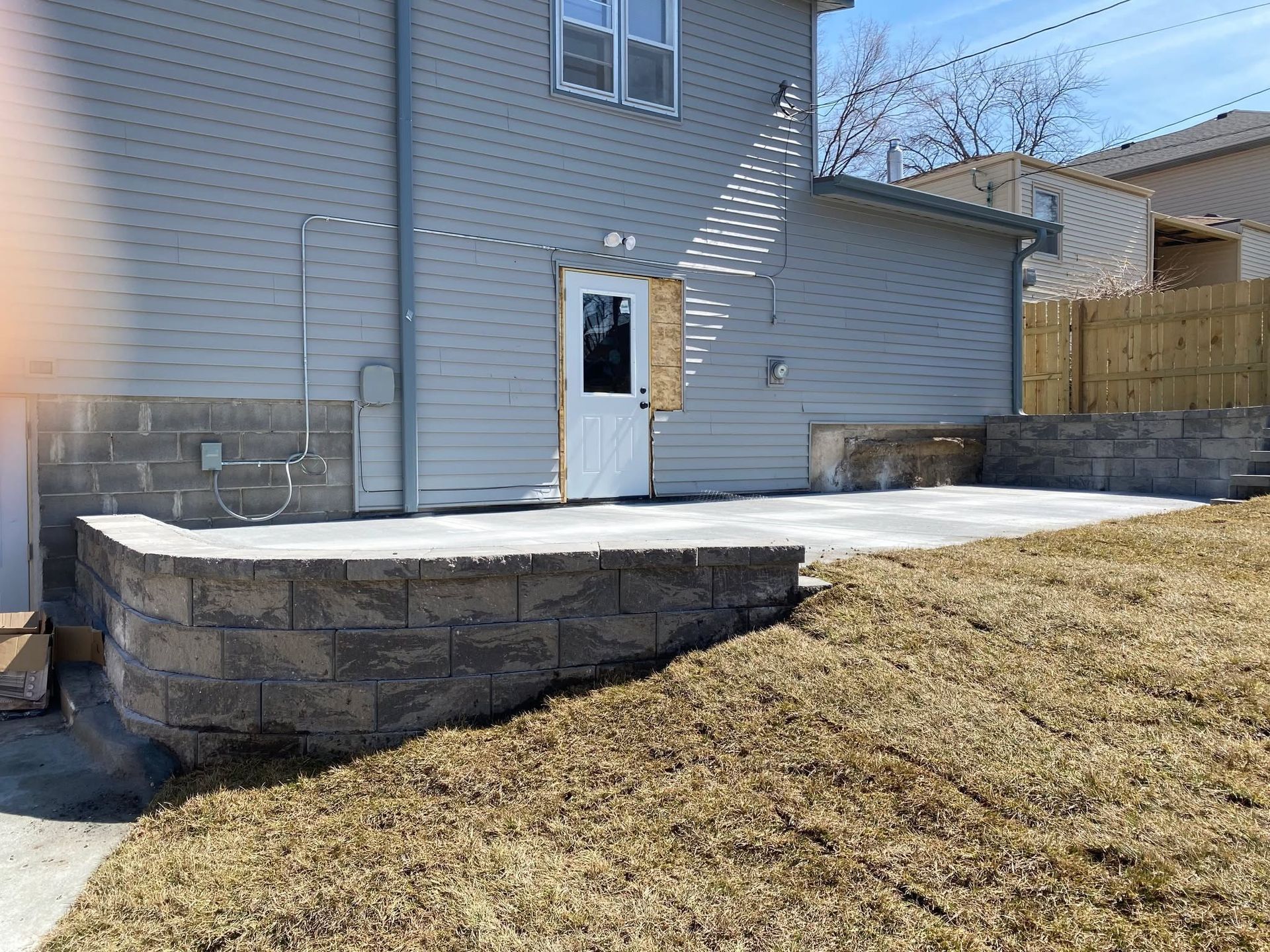 A house with a concrete patio in front of it.