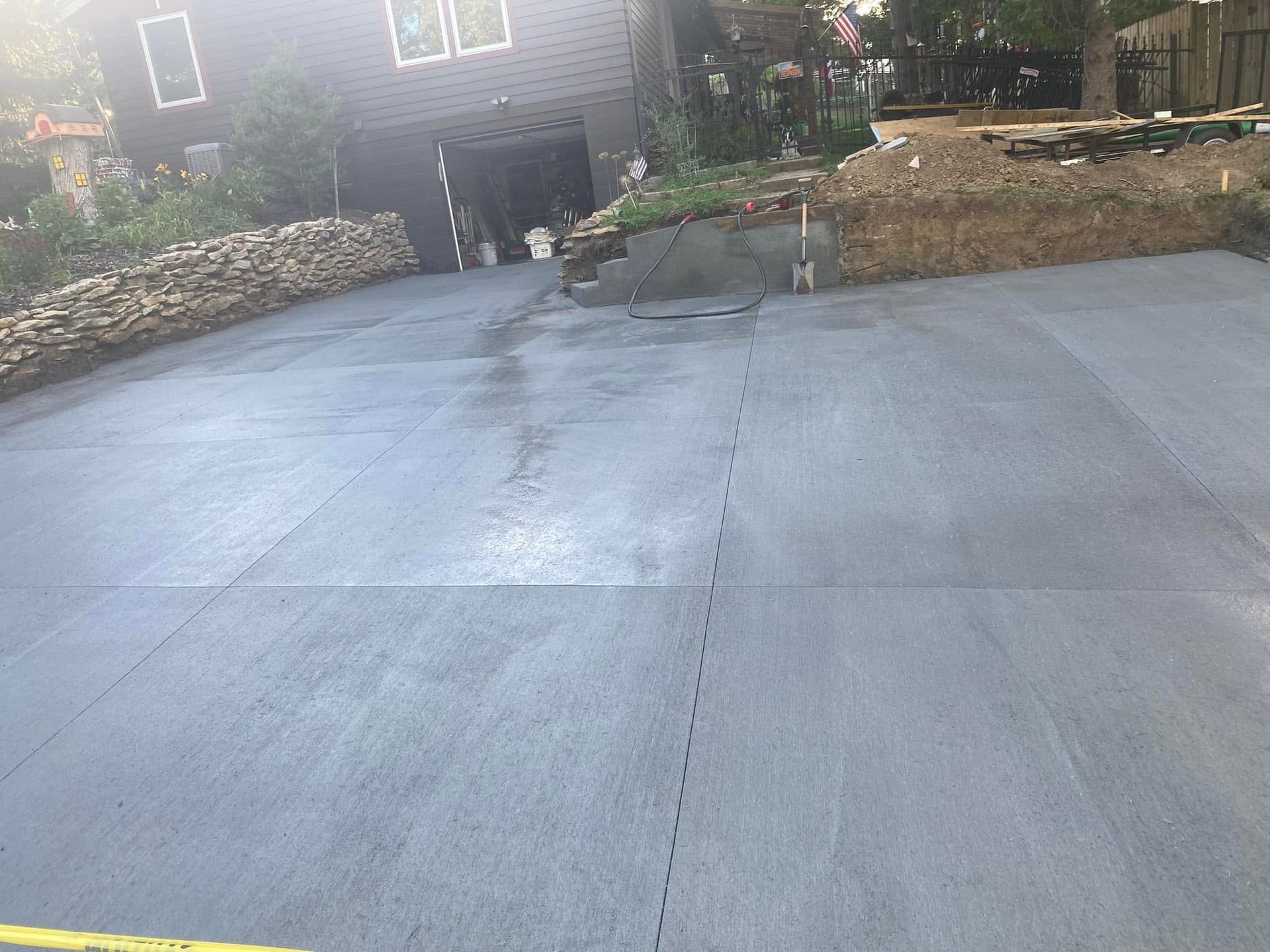 A concrete driveway is being built in front of a house.