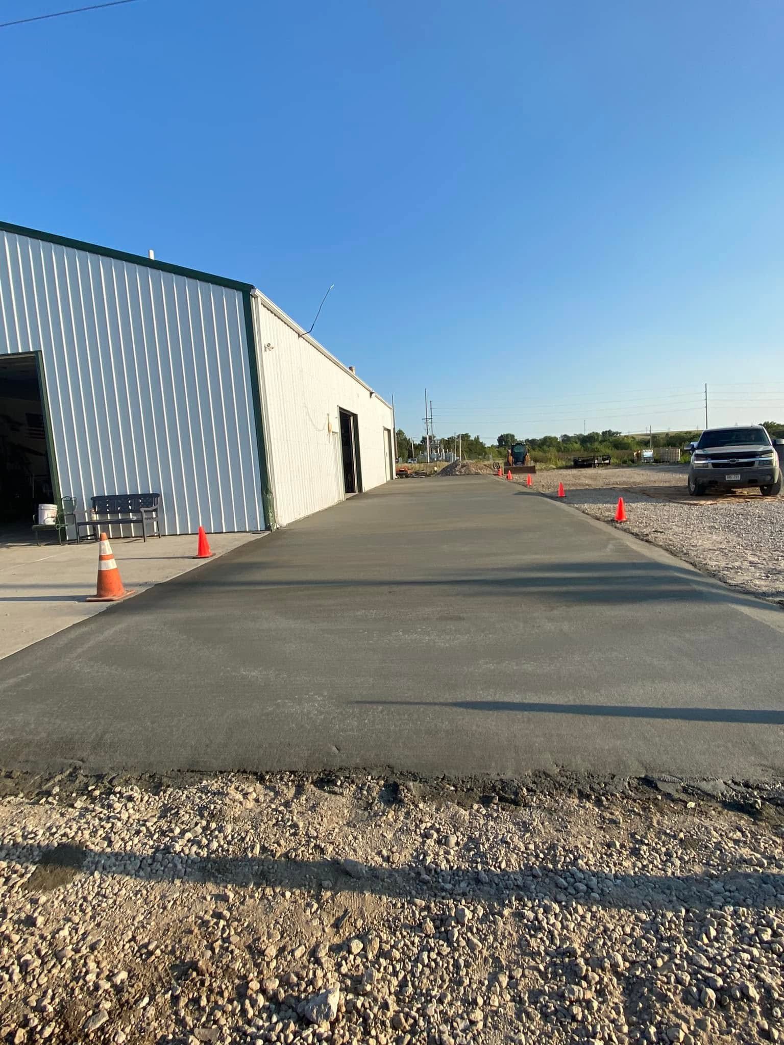 A concrete driveway is being built in front of a building.