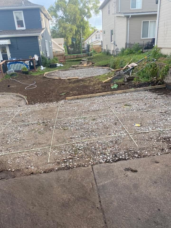 A concrete driveway is being built in front of a house.