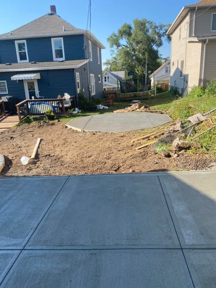 A concrete driveway is being built in front of a house.