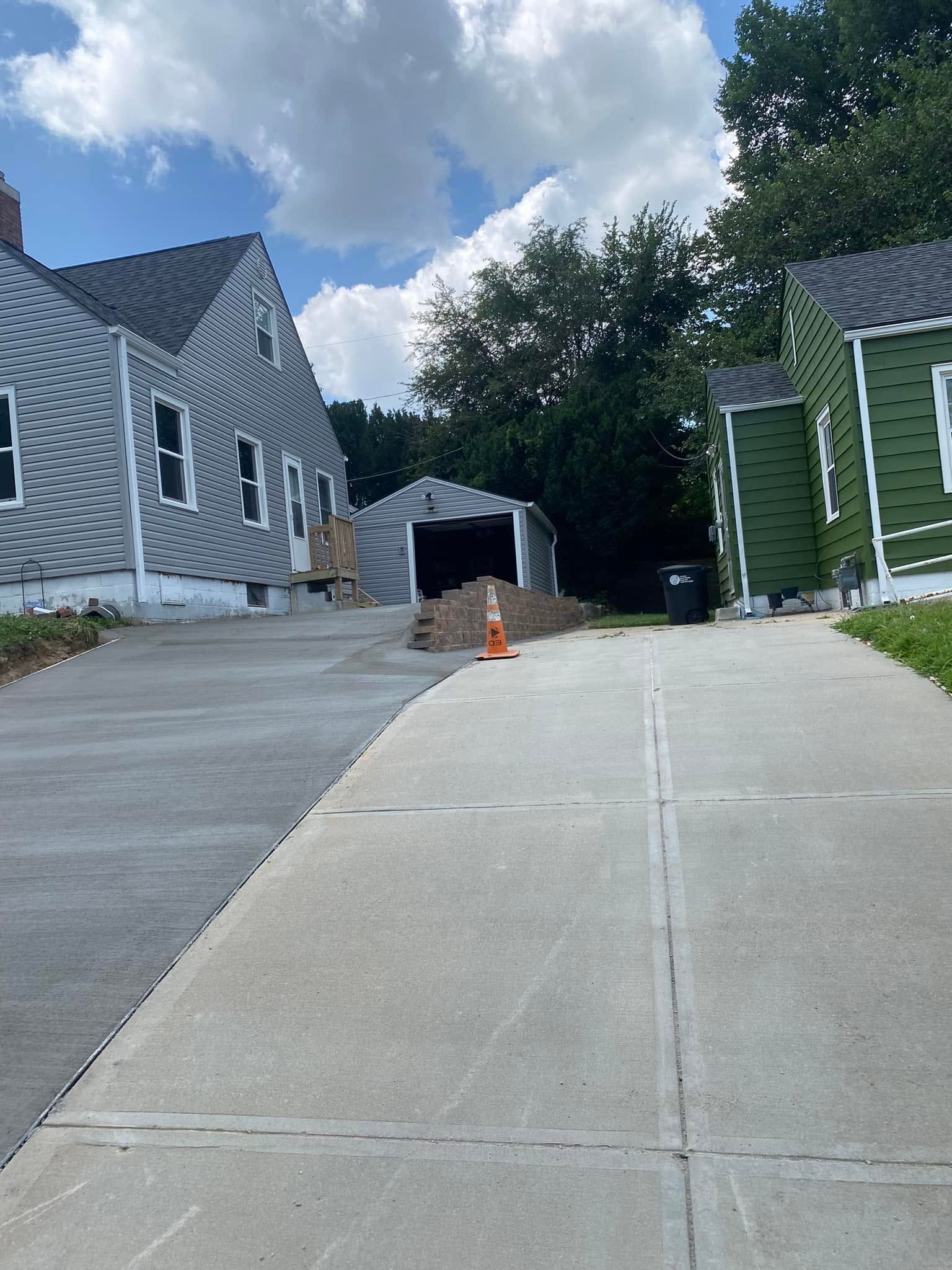 A concrete walkway leading to a row of houses