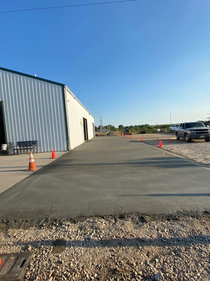 A concrete driveway is being built in front of a building.