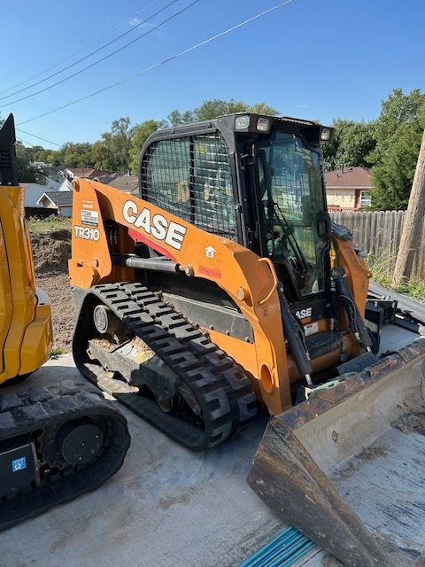 A case bulldozer is parked next to a yellow excavator.