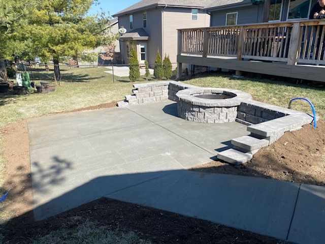 There is a fire pit in the backyard of a house.