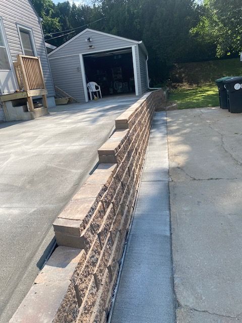 A brick wall is being built in front of a garage.