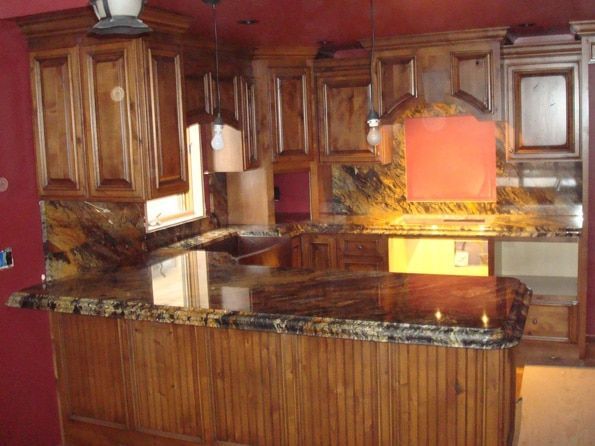 A kitchen with wooden cabinets and granite counter tops