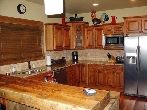 A kitchen with stainless steel appliances and wooden cabinets