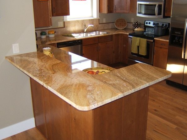 A kitchen with granite counter tops and stainless steel appliances