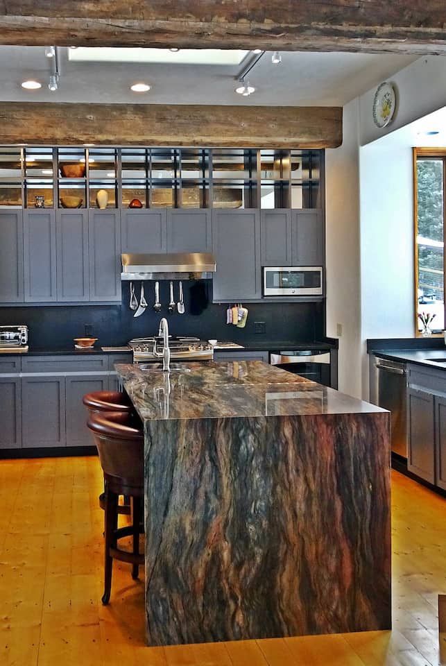A kitchen with a large island in the middle