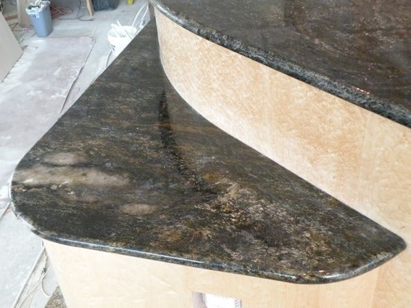 A black granite counter top with a curved edge
