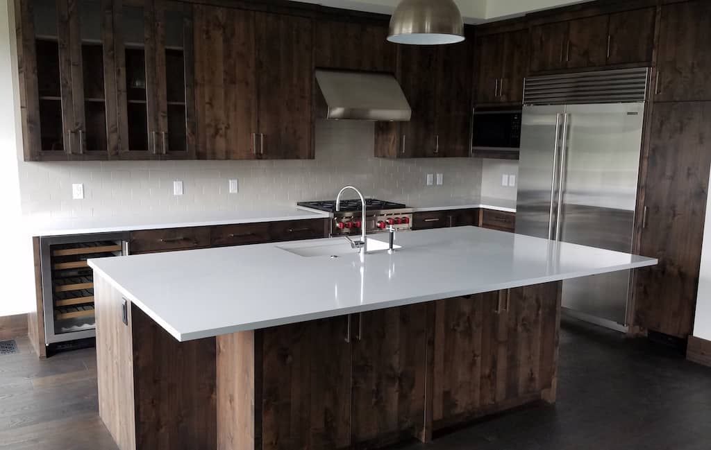 A kitchen with stainless steel appliances and wooden cabinets