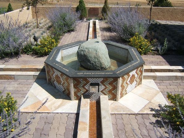 A fountain with a large rock in the middle of it