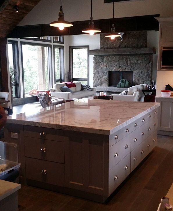 A kitchen with a large island and a fireplace