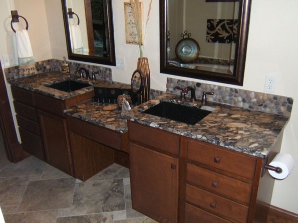 A bathroom with two sinks and two mirrors