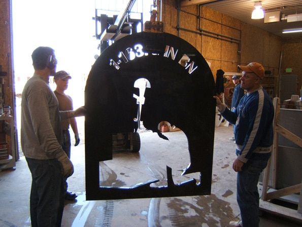 A group of men standing around a sign that says ' nfn ' on it