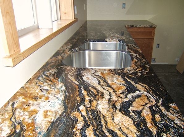 A kitchen counter with a sink and a window