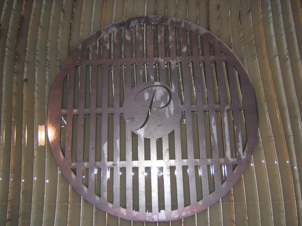 A drain cover with the letter p on it