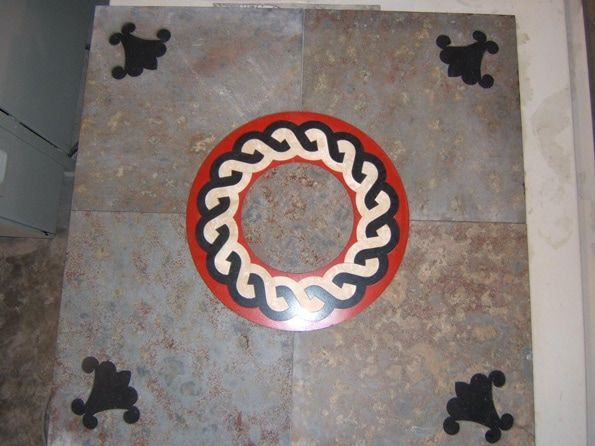 A red and white circle with black swirls on it