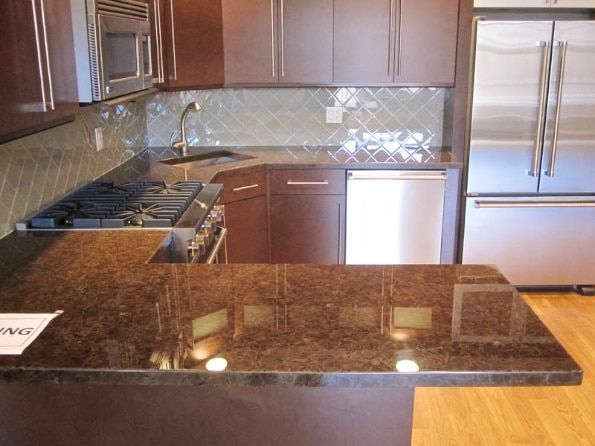 A kitchen with stainless steel appliances and granite counter tops