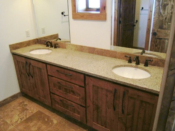 A bathroom with two sinks and a large mirror.