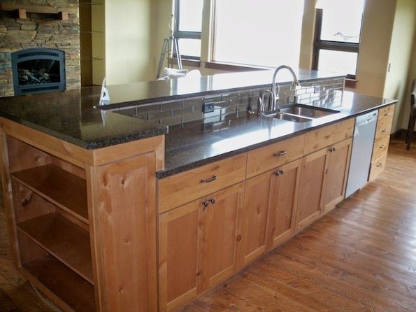 A kitchen with wooden cabinets and granite counter tops