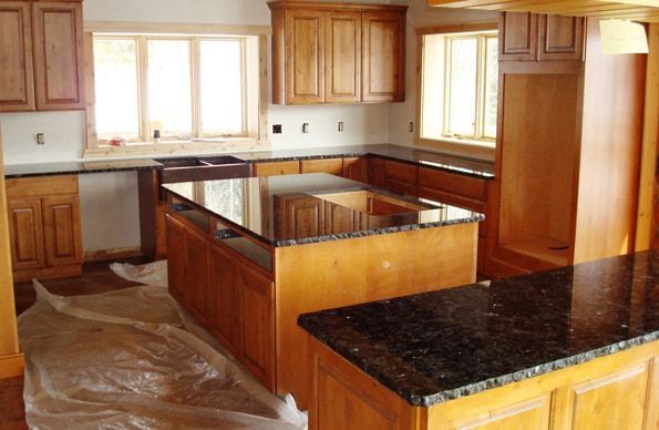 A kitchen with wooden cabinets and granite counter tops